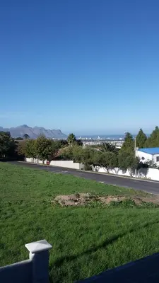 a view of a road and a field of grass at Barlinka lane Selfcatering flatlet , Somerset West in Cape Town