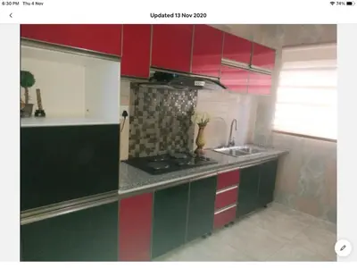 a kitchen with red and green cabinets and a sink at Tia Maria House in Cape Town
