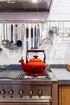 a red pot sitting on top of a stove in a kitchen at Luxury Apartments - Rozenhof Villa in Stellenbosch