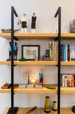 a book shelf with toys and books on it at Luxury Apartments - Rozenhof Villa in Stellenbosch