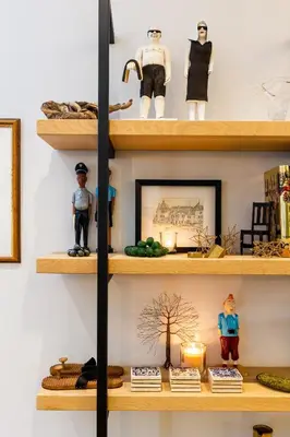 a shelf filled with figurines and a surfboard at Luxury Apartments - Rozenhof Villa in Stellenbosch