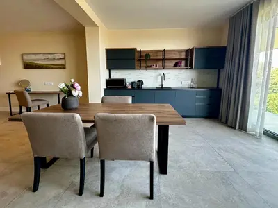 a dining room with a wooden table and chairs at Cape Vermeer in Somerset West