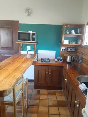 a kitchen with a wooden counter top with a stove at Upstairs in Cape Town