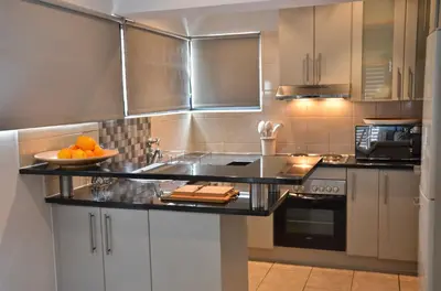 a kitchen with a counter with oranges on it at Concord Modern Apartment in Stellenbosch in Stellenbosch
