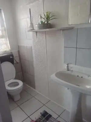 a white bathroom with a toilet and a sink at Self Catering unit7 , Sandbaai in Hermanus