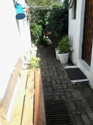 a wooden bench sitting outside of a house at Self Catering unit7 , Sandbaai in Hermanus