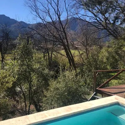a swimming pool with a view of the mountains at Little Willow Brooke in Franschhoek