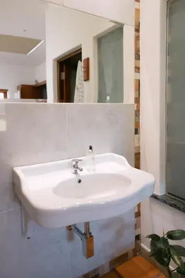a white sink in a bathroom with a mirror at La Roche Estate in Franschhoek
