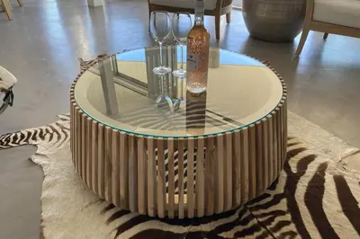 a coffee table with wine glasses on top of a rug at Dolphin Beach Villa E24 direct access to the beach in Cape Town