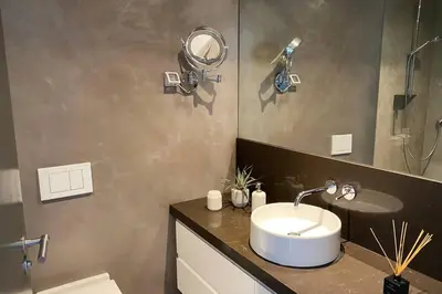 a bathroom with a sink and a mirror at Dolphin Beach Villa E24 direct access to the beach in Cape Town