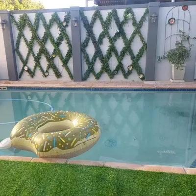 a pool with a donut float in the water at Bachelor cottage STRICTLY HALAAL Garlandale Rondebosch East in Cape Town