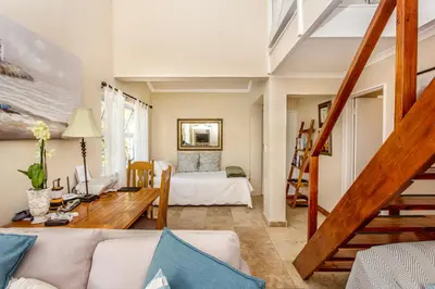 a living room with a couch and a table at Invergara in Cape Town