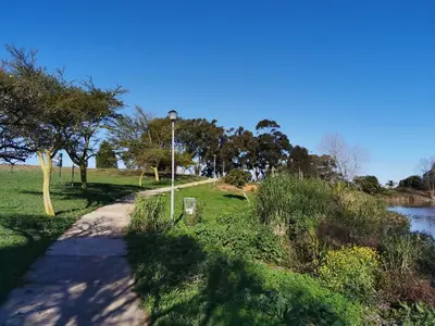 a path in a park next to a river at Protea Suite in Bellville