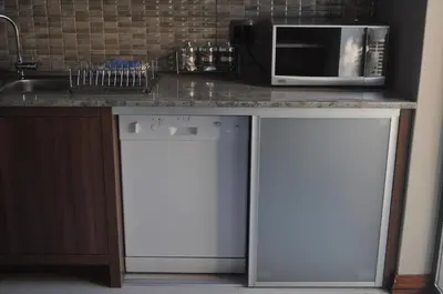 a kitchen with a counter with a microwave and a dishwasher at A Perfect Self Catering in Wellington