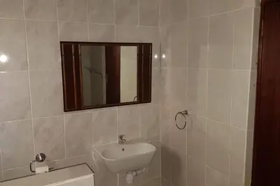 a bathroom with a sink and a mirror at Le Grec Wine Tram Apartment #3 in Franschhoek
