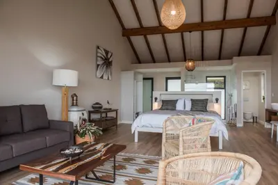 a living room with a bed and a couch at Ridge House in Hermanus