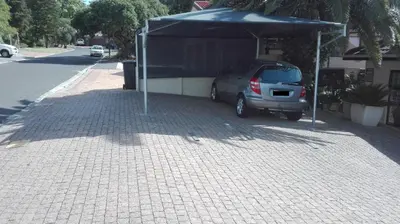 a car parked under a canopy on a street at La Grâce, Durbanville in Cape Town