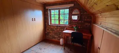 a small room with a desk and a window at Cozy Cottage +/- 500m from the beach in Cape Town