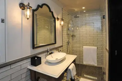 a white bathroom with a sink and a mirror at Southern Sun de Wagen in Stellenbosch