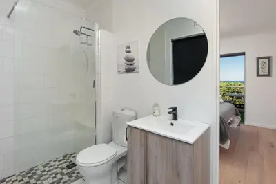 a bathroom with a toilet and a sink and a mirror at 64 Whalerock Estate in Hermanus