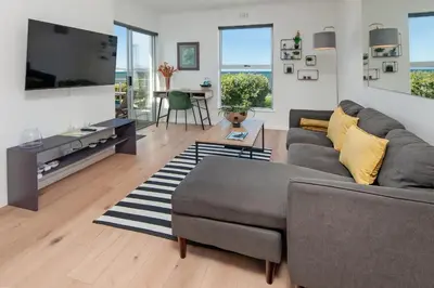 a living room with a couch and a tv at 64 Whalerock Estate in Hermanus
