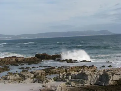 a wave crashing on the rocks in the ocean at Thundering waves in Bettyʼs Bay