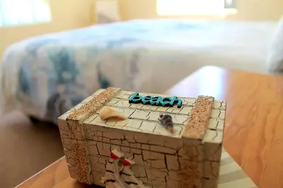 a toy chest sitting on a table next to a bed at Waters Breakaway in Bloubergstrand