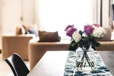 a vase of flowers sitting on a table at Seagull Hermanus in Hermanus