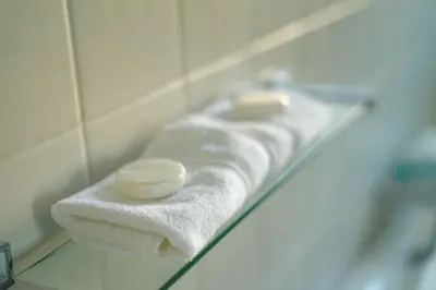 a bathroom with white towels and a sink at Seagull Hermanus in Hermanus