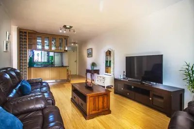 a living room with a couch and a flat screen tv at Portifino On Lake G16 The Island Club in Cape Town
