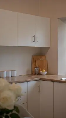 a kitchen with white cabinets and a counter top at Hoogwater Garden Cottage in Wolseley