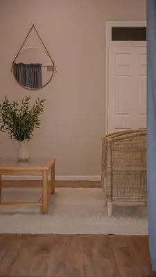 a living room with a table and a mirror at Hoogwater Garden Cottage in Wolseley