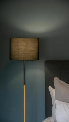 a lamp sitting next to a bed in a bedroom at Hoogwater Garden Cottage in Wolseley