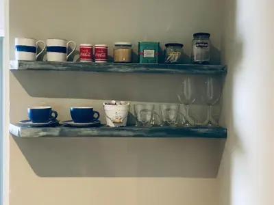a shelf with cups and glasses on it at The West Wing guest suite. Pringle Bay. in Pringle Bay
