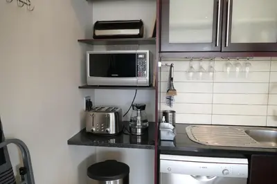 a small kitchen with a sink and a microwave at Little Venice Self Catering in Bellville