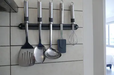 a group of kitchen utensils hanging on a wall at Little Venice Self Catering in Bellville