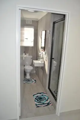 a bathroom with a toilet and a sink at Hermanus Beach Club - Le Maree House 18 in Hermanus