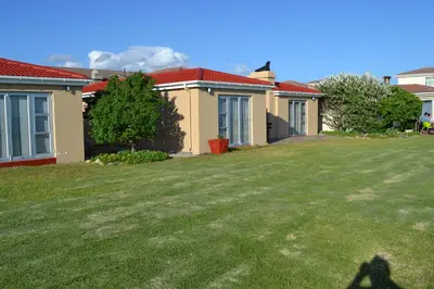 a house with a lawn in front of it at Hermanus Beach Club - Le Maree House 18 in Hermanus