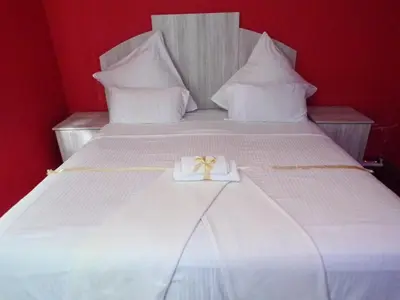 a white box with a bow on top of a bed at Khaya B&B Mandalay in Cape Town