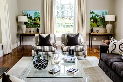 a living room with two couches and a glass table at Brookdale Estate - Manor House in Paarl