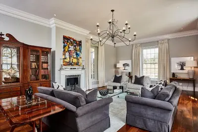 a living room filled with furniture and a chandelier at Brookdale Estate - Manor House in Paarl