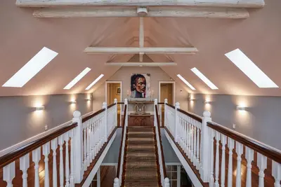 a staircase in a building with a painting on the wall at Brookdale Estate - Manor House in Paarl
