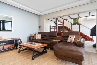 a living room with two couches and a coffee table at Zaria Sun Family in Cape Town