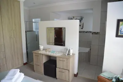 a bathroom with a sink and a mirror at Piece of Paradise in Hermanus