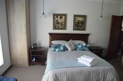 a bedroom with a bed with towels on it at Piece of Paradise in Hermanus