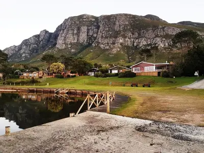 a mountain and some houses and a body of water at Lagoon Edge in Hermanus
