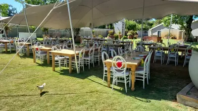 a group of tables and chairs under a tent at Cape Winelands Business Villas in Joostenberg Vlakte