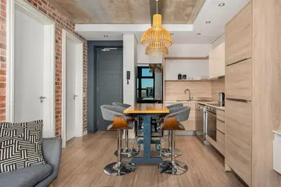 a kitchen with a table and chairs in a room at Matrix Apartments in Cape Town