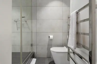 a bathroom with a toilet and a shower at Matrix Apartments in Cape Town