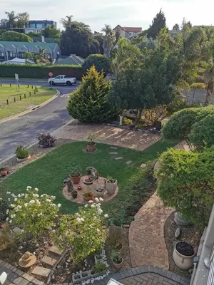 an aerial view of a garden with flowers and plants at Guinea Fowl Self Catering in Cape Town